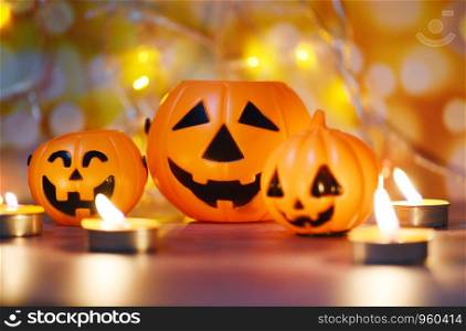 Halloween background candlelight orange decorated holidays festive concept / funny faces jack o lantern pumpkin halloween decorations for party accessories object with candle light bokeh