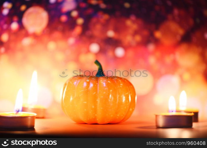 Halloween background candlelight orange decorated holidays festive concept / pumpkin halloween decorations for party accessories object with candle light bokeh
