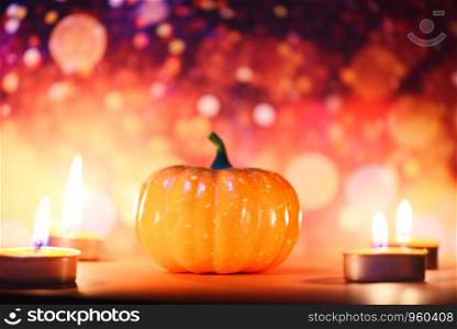Halloween background candlelight orange decorated holidays festive concept / pumpkin halloween decorations for party accessories object with candle light bokeh