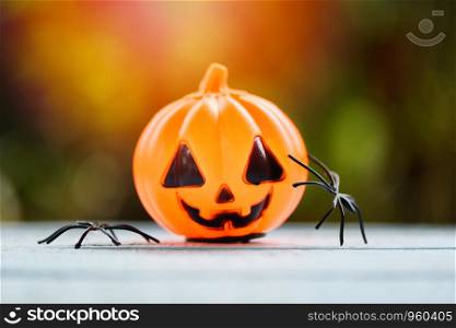 Halloween background decorated holidays festive concept / spider and lantern pumpkin halloween decorations for party accessories object on wooden nature