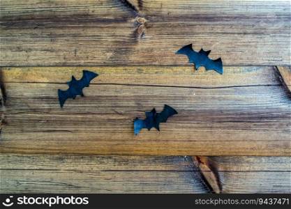 Halloween background. Paper black bats on a wooden background. Background for advertising.