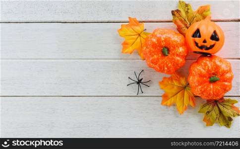 halloween background with dry leaves autumn on wooden decorated holidays festive concept / jack o lantern pumpkin halloween decorations for party accessories object and spider , top view flat lay