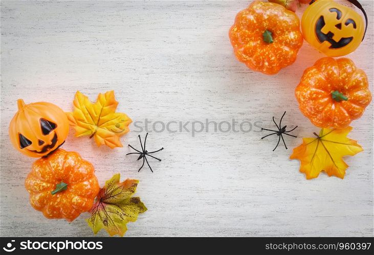 halloween background with dry leaves autumn on wooden decorated holidays festive concept / jack o lantern pumpkin halloween decorations for party accessories object , top view flat lay