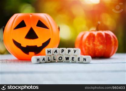 Halloween background with word blocks happy halloween decorations and pumpkin jack o lantern funny spooky on wooden table happy holiday concept