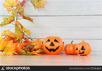 Halloween background wooden decorated holidays festive concept / leaves autumn and jack o lantern pumpkin halloween decorations for party accessories object