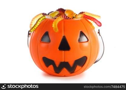 Halloween candies in Jack-O-Lantern bag isolated on white background. Halloween candies in Jack-O-Lantern bag