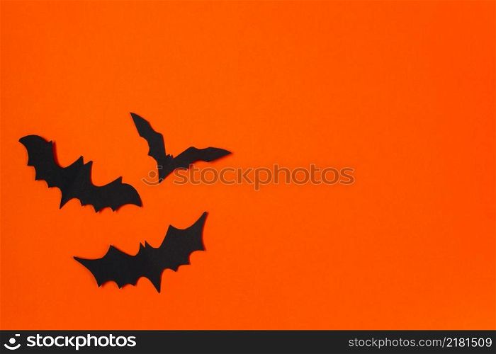 Halloween concept. Festive decorations. Bats on an orange background.. Halloween concept. Festive decorations. Bats on orange background.