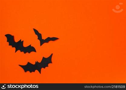 Halloween concept. Festive decorations. Bats on an orange background.. Halloween concept. Festive decorations. Bats on orange background.