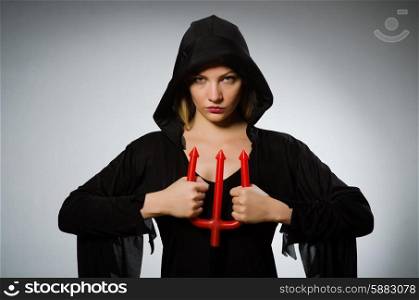 Halloween concept with woman holding pitchfork