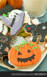 Halloween cookies with different shapes and glass milk. Sweet tradition