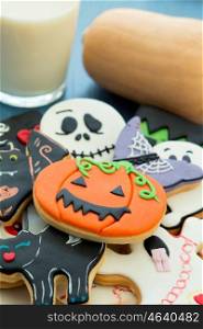 Halloween cookies with different shapes and glass milk. Sweet tradition
