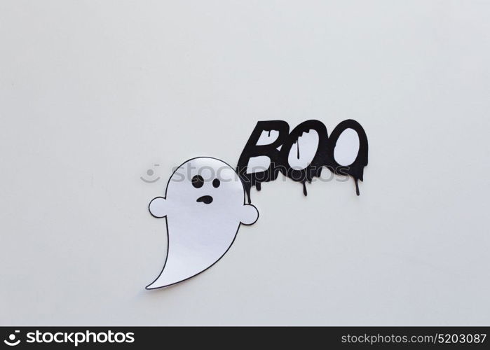 halloween, decoration and scary concept - paper ghost doodle and word boo over white background. ghost doodle and word boo on white background