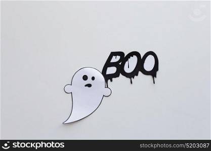 halloween, decoration and scary concept - paper ghost doodle and word boo over white background. ghost doodle and word boo on white background
