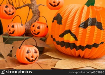 Halloween decoration. Hanging pumpkins on a dry tree