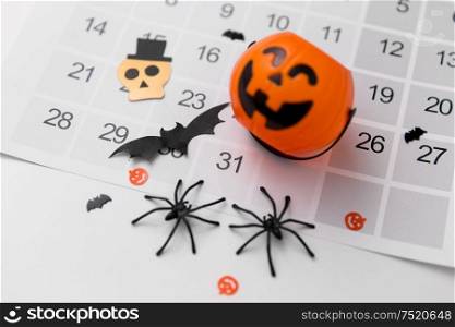 halloween, decorations and holidays concept - jack o lantern, spiders, bats and calendar on white background. halloween party decorations and calendar