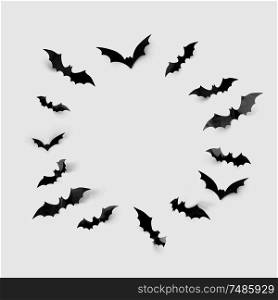 halloween decorations concept - black paper bats in circle on grey background. black halloween bats in circle