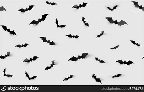 halloween decorations concept - seamless pattern with black paper bats on grey background. seamless pattern with halloween bats