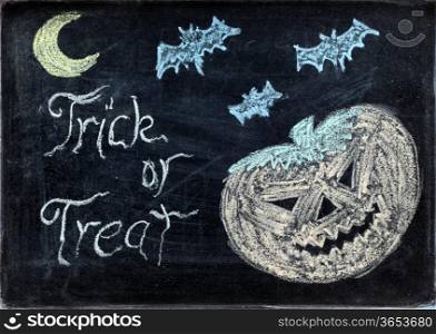 halloween drawing on chalkboard or blackboard with trick or treat