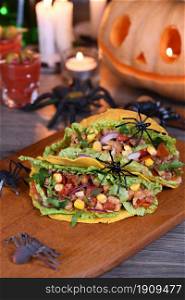 Halloween Food. Mexican corn tortilla tacos with vegetables and chicken. Add some burning gustatory color to your party