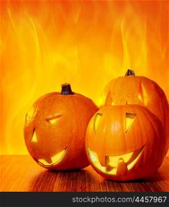 Halloween glowing pumpkins over bright fire yellow background, with copy space, autumn holiday traditional party decoration, fun concept