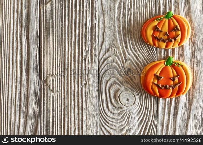 Halloween homemade gingerbread cookies over wooden background