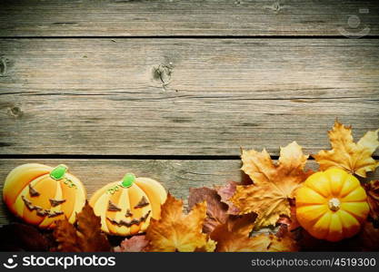 Halloween homemade gingerbread cookies over wooden background