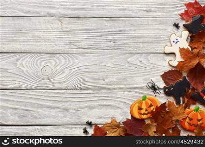 Halloween homemade gingerbread cookies over wooden background