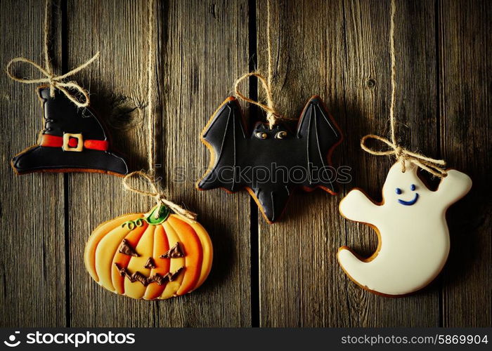 Halloween homemade gingerbread cookies over wooden background