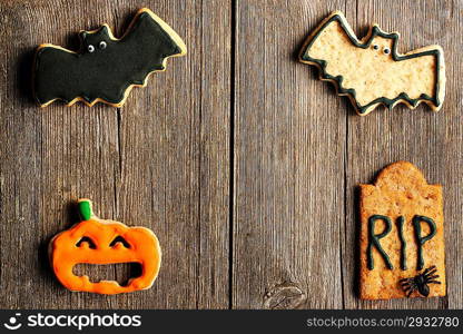 Halloween homemade gingerbread cookies over wooden table