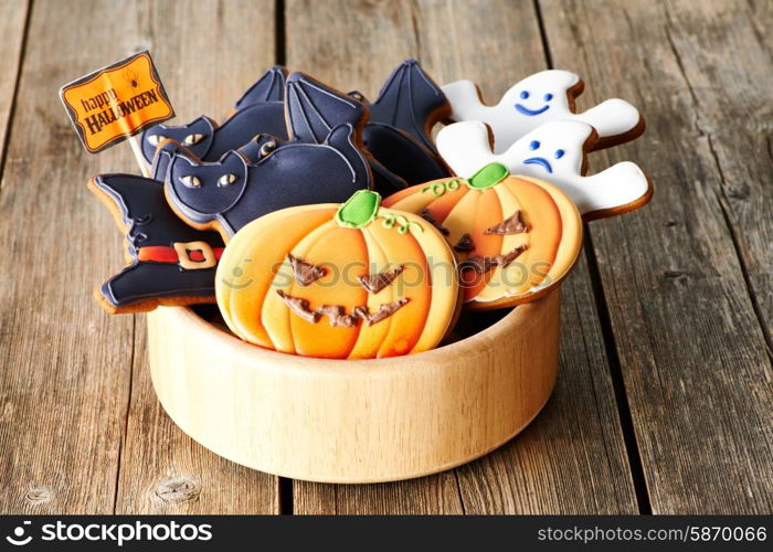 Halloween homemade gingerbread cookies over wooden table