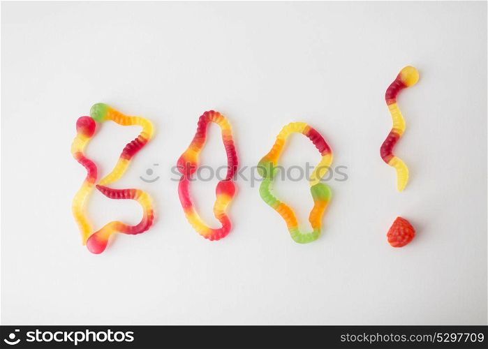 halloween, junk food and confectionery concept - word boo made of gummy worms on white background. word boo made of gummy worms for halloween