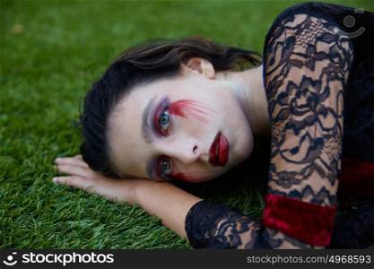 Halloween kid girl custome with bloody makeup on backyard turf
