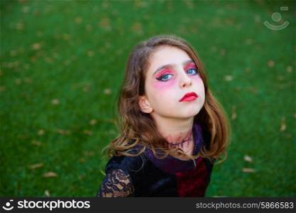 Halloween makeup kid girl blue eyes in outdoor backyard lawn