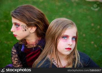 Halloween makeup kid sister girls blue eyes in outdoor backyard lawn