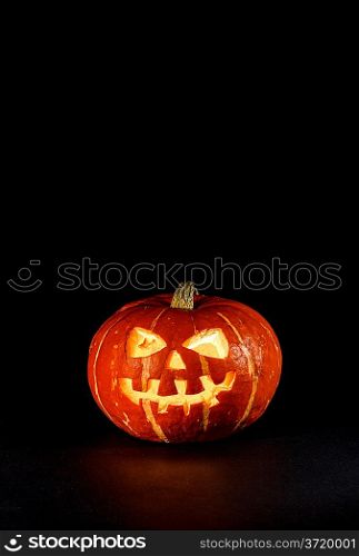 Halloween - old jack-o-lantern on black background