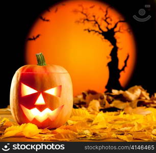 Halloween orange pumpkin lantern with autumn leaves