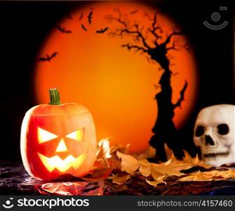 Halloween orange pumpkin lantern with autumn leaves
