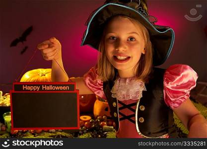 Halloween party with a child holding sign in hand