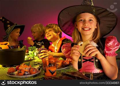 Halloween party with children having fun in fancy costumes