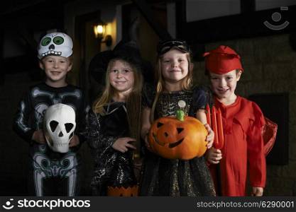 Halloween Party With Children Trick Or Treating In Costume