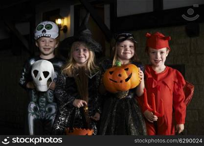 Halloween Party With Children Trick Or Treating In Costume