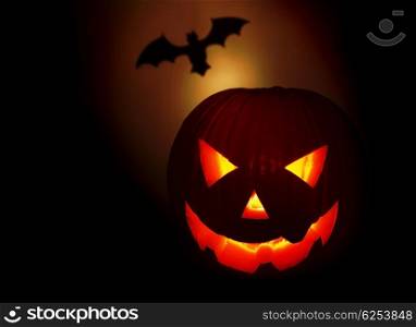 Halloween pumpkin and bat isolated on black background