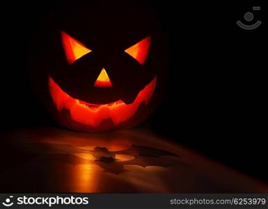 Halloween pumpkin and bat isolated on black background