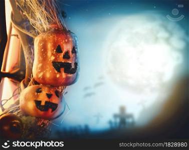 Halloween pumpkin and graveyard blurred background in the full moon night with copy space,halloween celebration concept