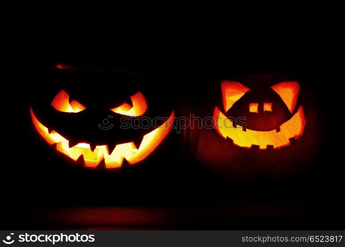 Halloween pumpkin heads jack lantern with scary evil faces on black. Halloween pumpkin heads