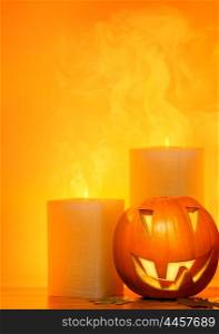 Halloween pumpkin holiday border, with candles and smoke, traditional jack-o-lantern over warm yellow light, night party decoration, fun concept