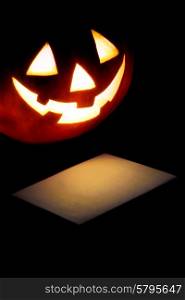 Halloween pumpkin lantern and post card isolated on black background. Halloween pumpkin and card