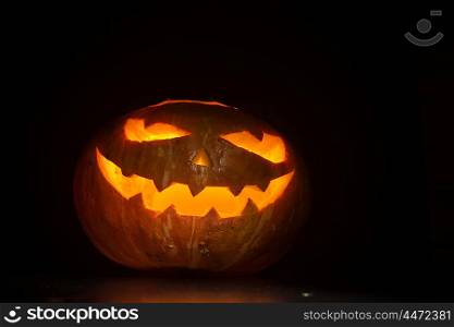 Halloween pumpkin on black. Halloween pumpkin with scary face on black backgound