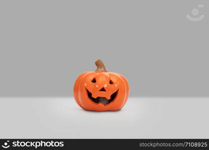 Halloween pumpkin on grey background. Halloween idea concept.