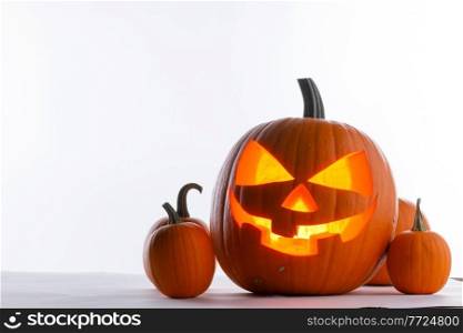 Halloween pumpkin with cut face and candle inside isolated on white background. Halloween pumpkins on white